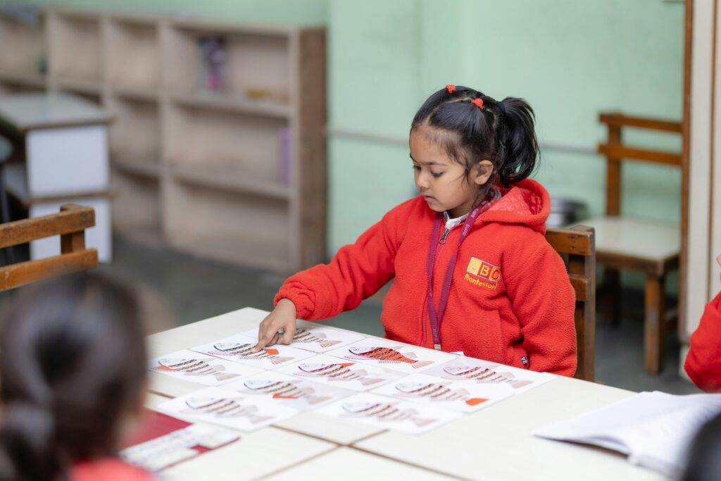 Child engaging in educational activity at school desk, promoting learning.